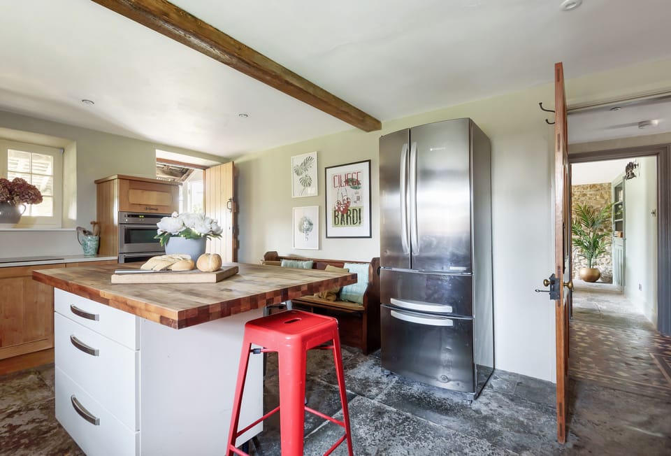 Lower Farm, Sherborne: Kitchen with island and Aga and door to the boot room