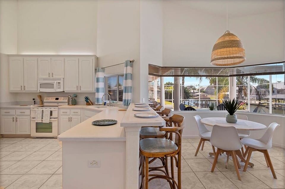 Fully equipped kitchen — cook, gather, and enjoy the view; Sunny breakfast nook overlooking the canal