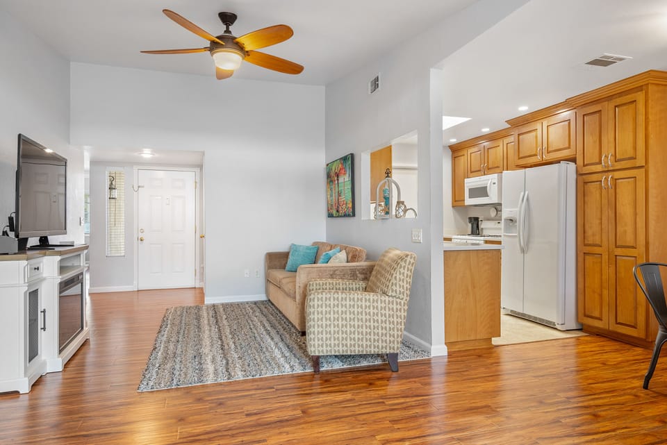 The living room has a SmartTV and faux fireplace.