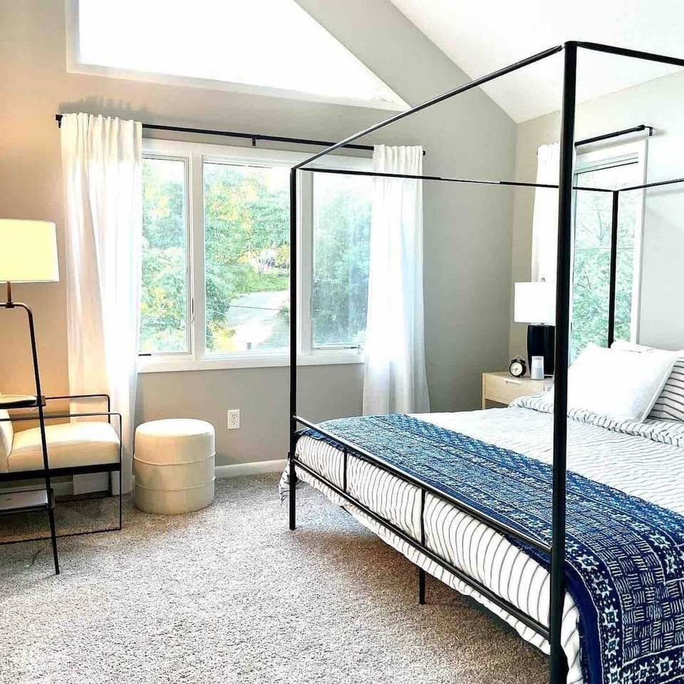 King sized canopy bed for sun filled master bedroom 