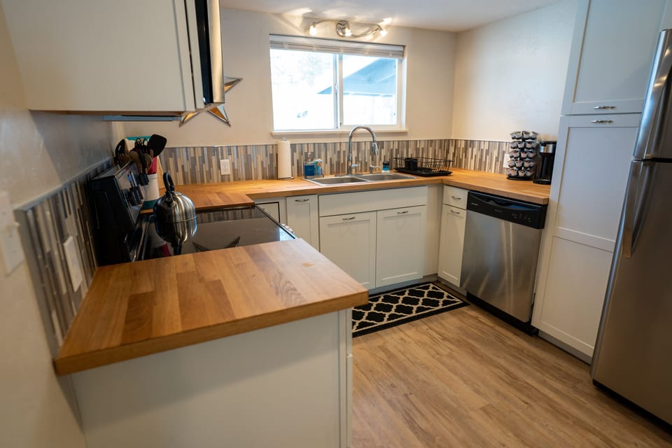 Full Kitchen with stove, oven, dishwasher, fridge, pots, pans, utensils, coffee