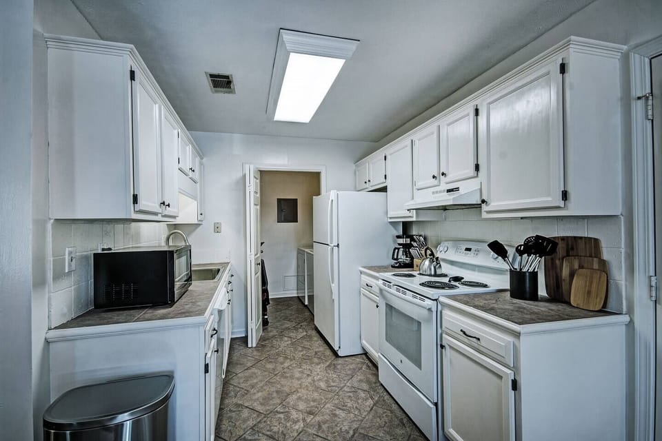 Kitchen view with the laundry room in the back. Perfect for a corporate stay.