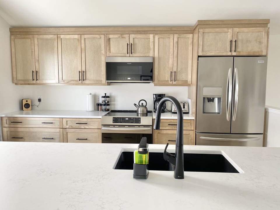 kitchen with induction stove, icemaker, coffee and espresso makers