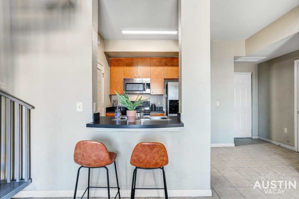 Bar seating for two across from the fully equipped kitchen