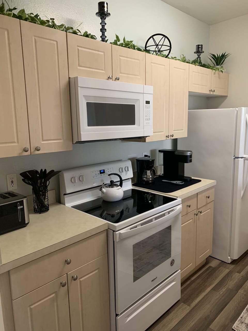 Full kitchen with microwave, stove, refrigerator, dishwasher, disposal.