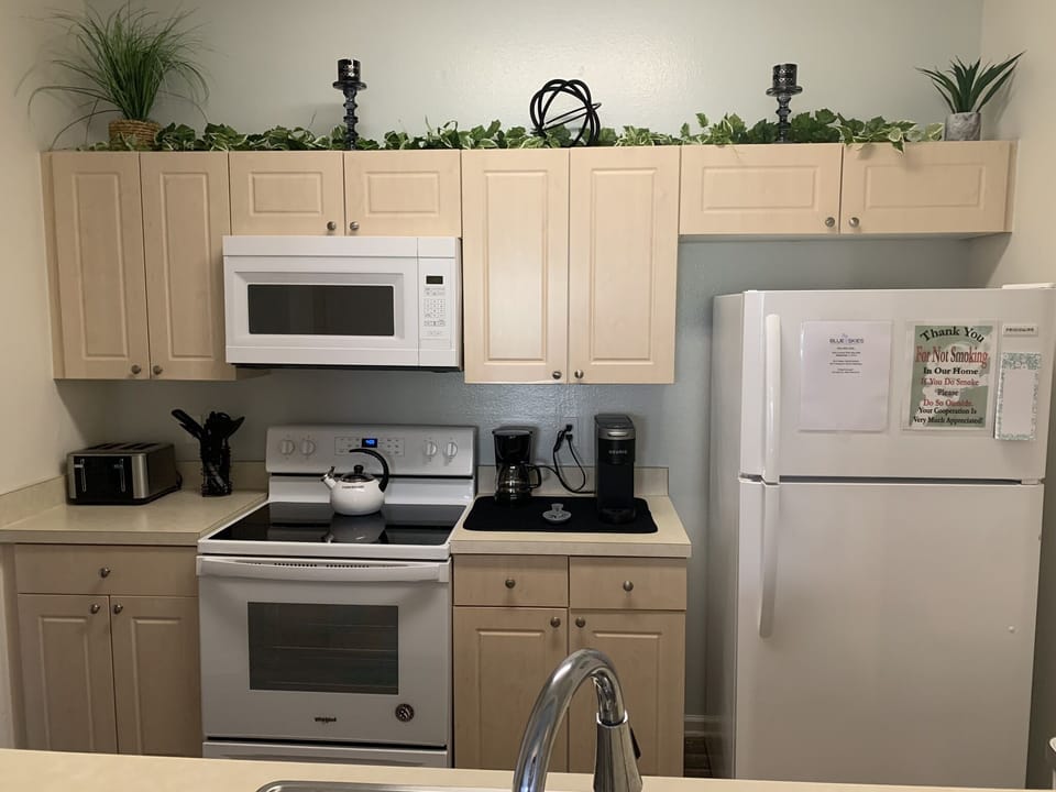 Full kitchen with microwave, stove, refrigerator, dishwasher, disposal.