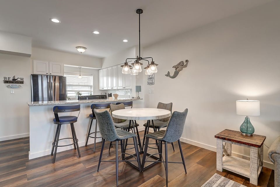 Your open-concept dining and kitchen space features a stylish round table perfect for intimate meals and morning coffee together.
