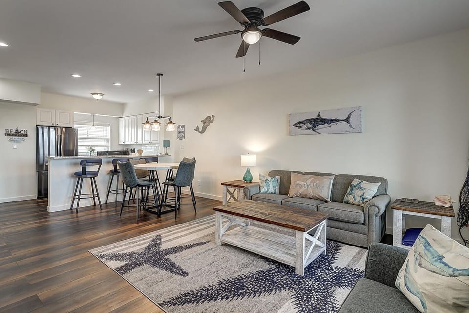 Relax in your coastal-themed living space where comfortable seating meets stylish nautical decor, perfect for unwinding after beach adventures.