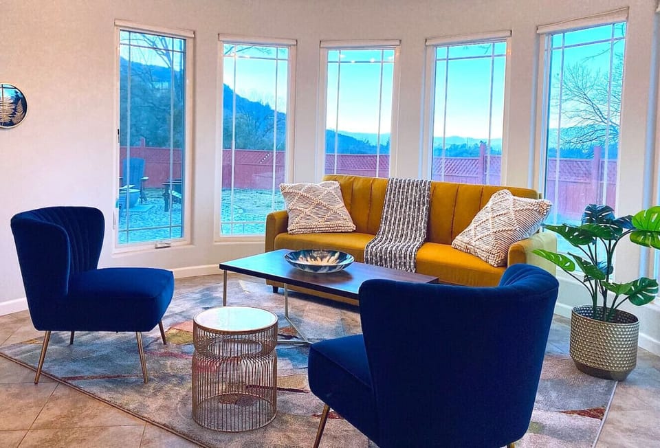 Sitting room with bay windows. Sofa bed pulls out with a queen sized mattress.
