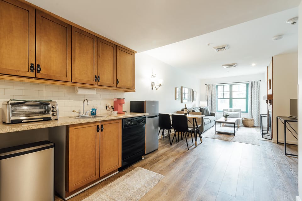 Galley kitchen with stove top, microwave, med sized fridge, etc