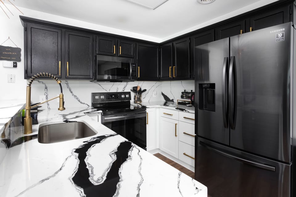 The NEWLY REMODELED Galley (kitchen) with dazzling quartz countertops