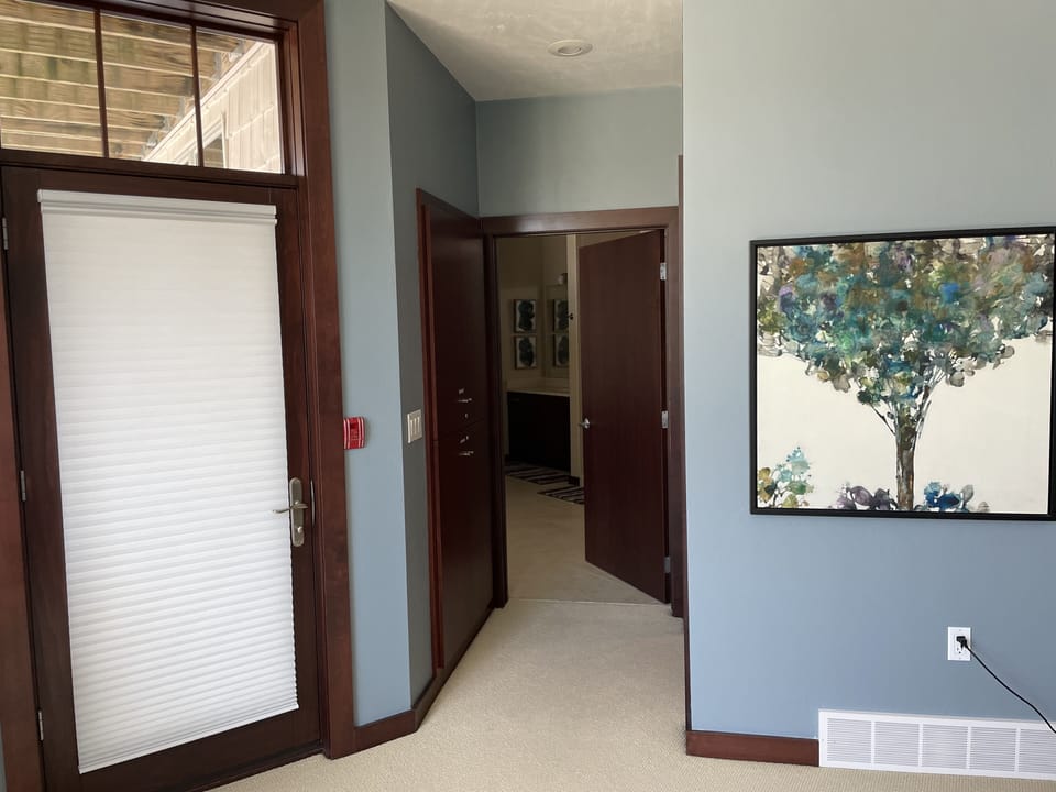 Main level primary bedroom en-suite and balcony access.