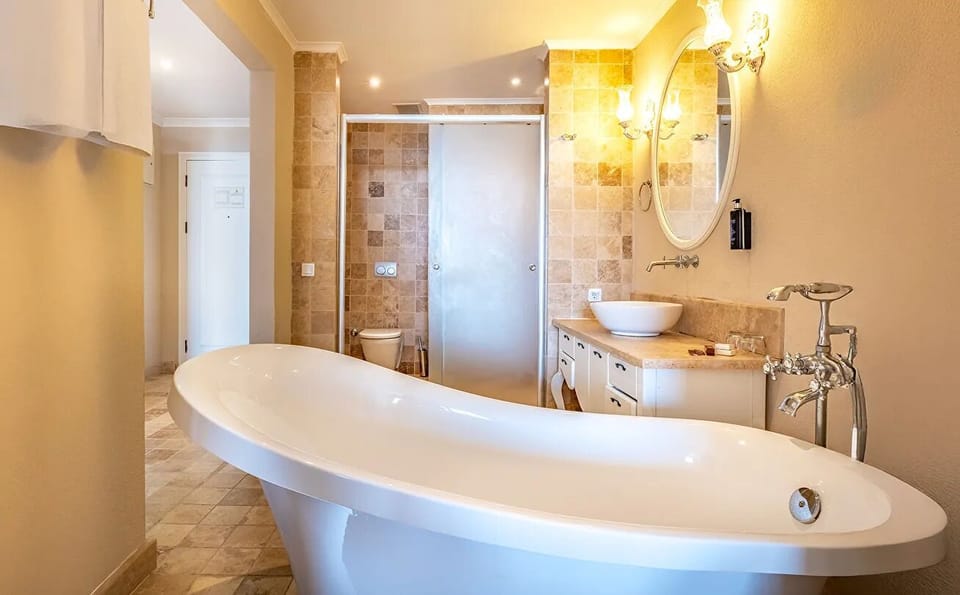Separate tub and shower, hair dryer, slippers, soap