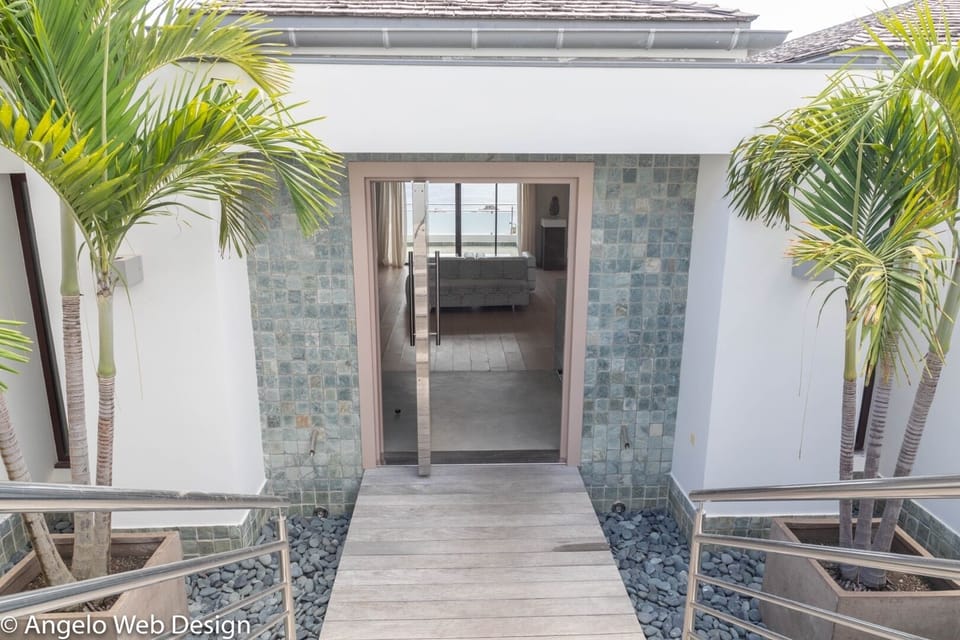 Outdoors: Tropical garden all around the property. Private entrance with parking spaces.