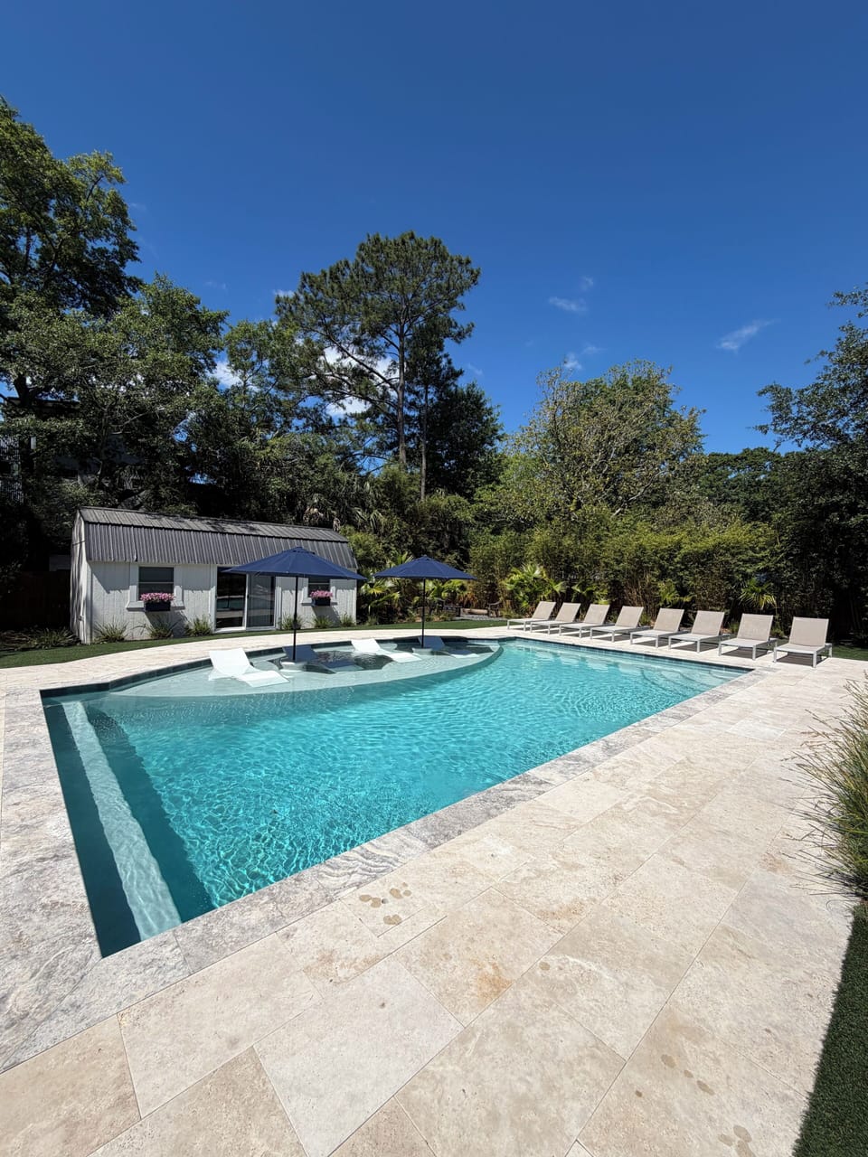 Saltwater pool with 8 lounge chairs and 4 Ledge Loungers