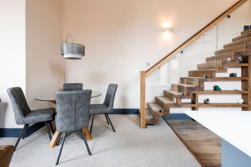Master bedroom with walk in wardrobe and en suite. We have incorporated amazing local art into our homes - supporting local craftsmen and business and bringing our guests the best Village Holiday they could imagine. Apartment 1 mezzanine bedroom, guests m