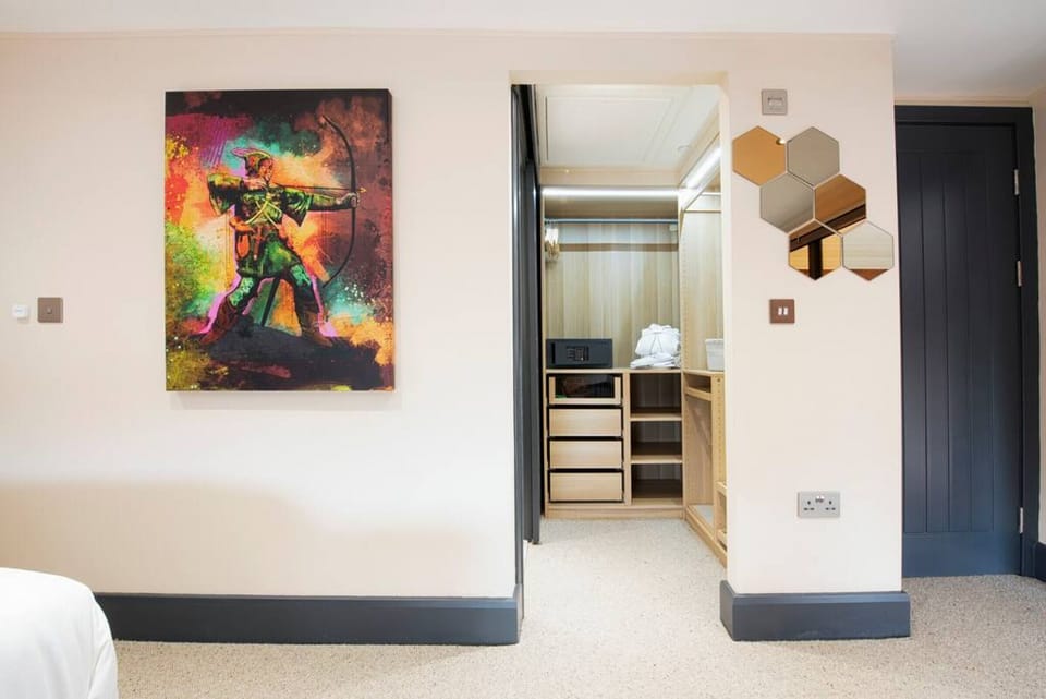 Master bedroom with walk in wardrobe and en suite. We have incorporated amazing local art into our homes - supporting local craftsmen and business and bringing our guests the best Village Holiday they could imagine.