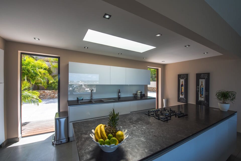 Kitchen: Kitchen at the rear of the great room, equipped with electric oven and gas stove, microwave