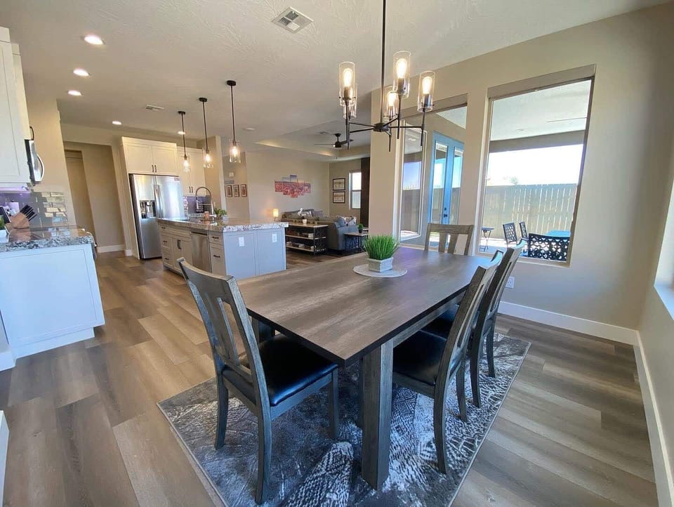 The dining table has plenty of seating for everyone to gather around and savor the culinary delights you’ve prepared.