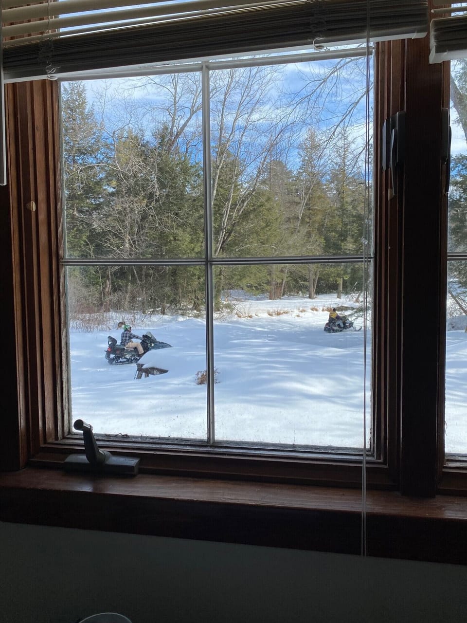 Snowmobilers on Shannon Brook heading towards Lake Winnipsaukee.
