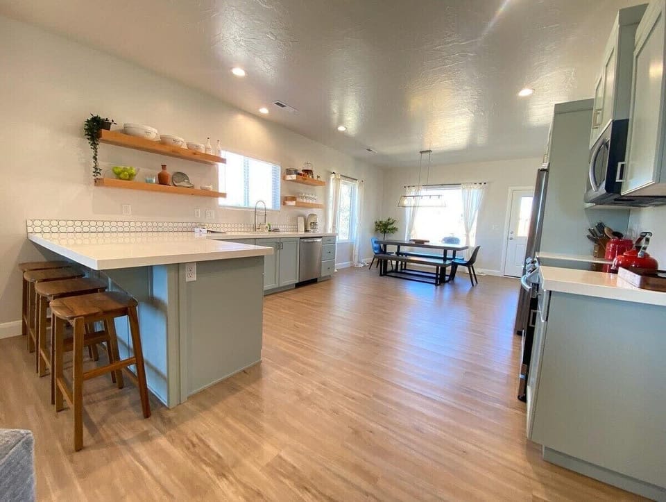 Serve up unforgettable family feasts in the heart of Ranchos Retreat. This fully equipped kitchen features everything you need, from top-of-the-line cookware to a cozy counter bar for sharing your masterpieces.