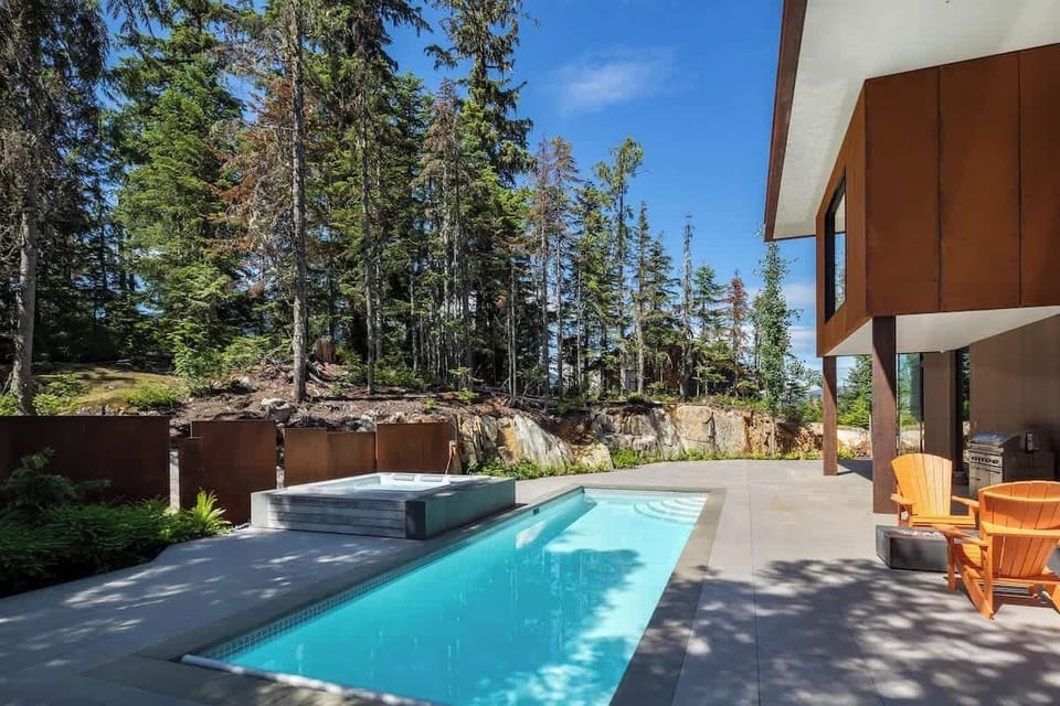 - Serene outdoor pool and hot tub surrounded by forest views  
- Spacious patio ideal for sunbathing and relaxing dips  
- Private oasis blending comfort and natural beauty  