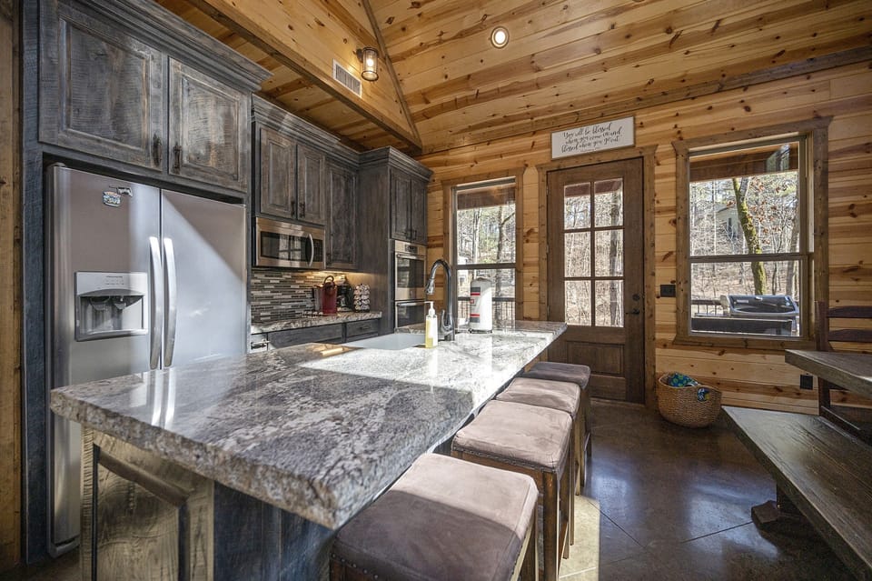 Large granite island with microwave, double oven, refrigerator