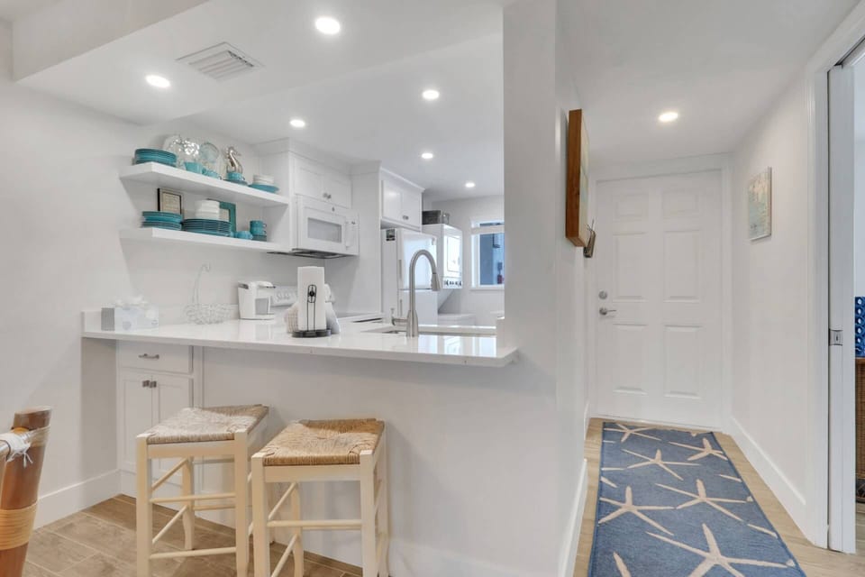The open kitchen is complete granite counters, full size appliances, and an eating bar with barstools.