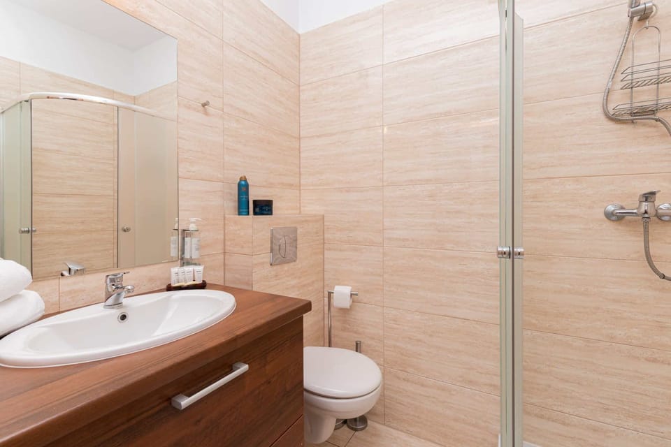 A closer look at the walk-in shower in the bathroom, featuring glass partitions and modern fixtures.