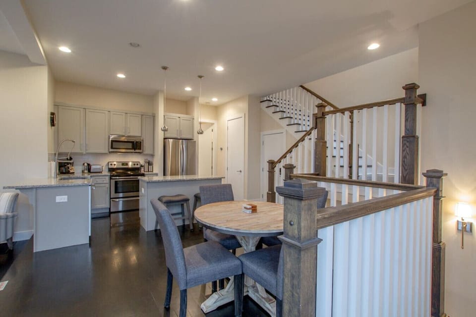 The upper landing overlooks the kitchen and dining area below.
