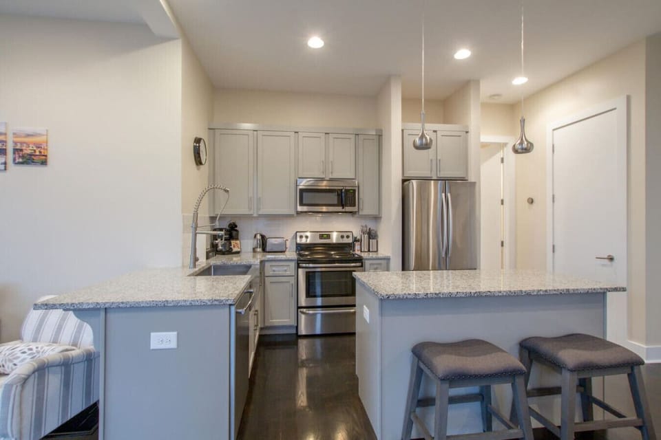 A well-equipped kitchen with granite counters and island bar seating.