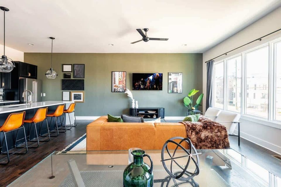 2nd Floor: Bright and open living room featuring a Smart TV,  Designer Furnishings and a dining room that seats 6 guests.
