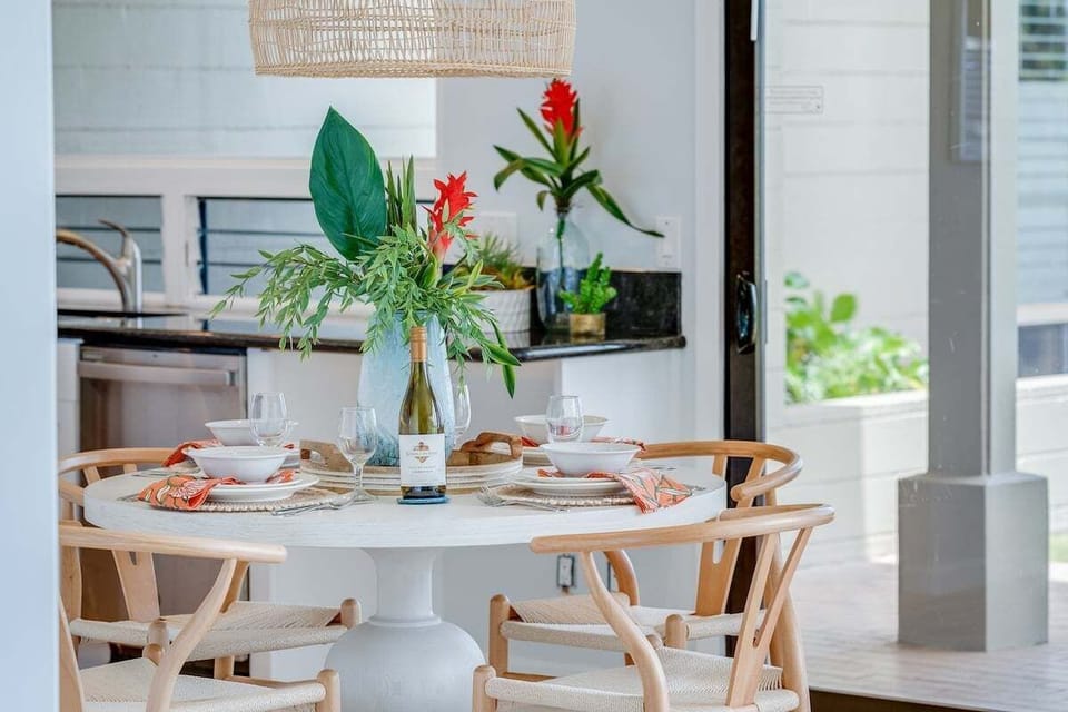 Inviting dining space with contemporary island décor, elegant table settings, and an open layout perfect for shared meals and gatherings.