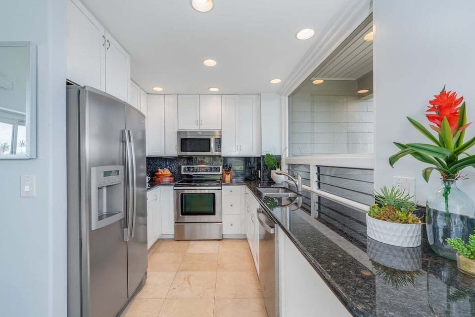 Contemporary kitchen with stainless steel appliances, sleek countertops, and thoughtful design, ideal for preparing meals while enjoying scenic views and effortless functionality.