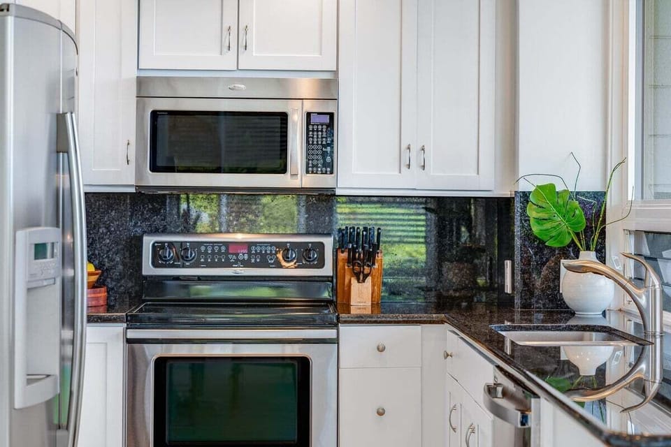 Well‑appointed kitchen featuring stainless steel appliances, modern finishes, and everything needed for convenient in‑home dining.
