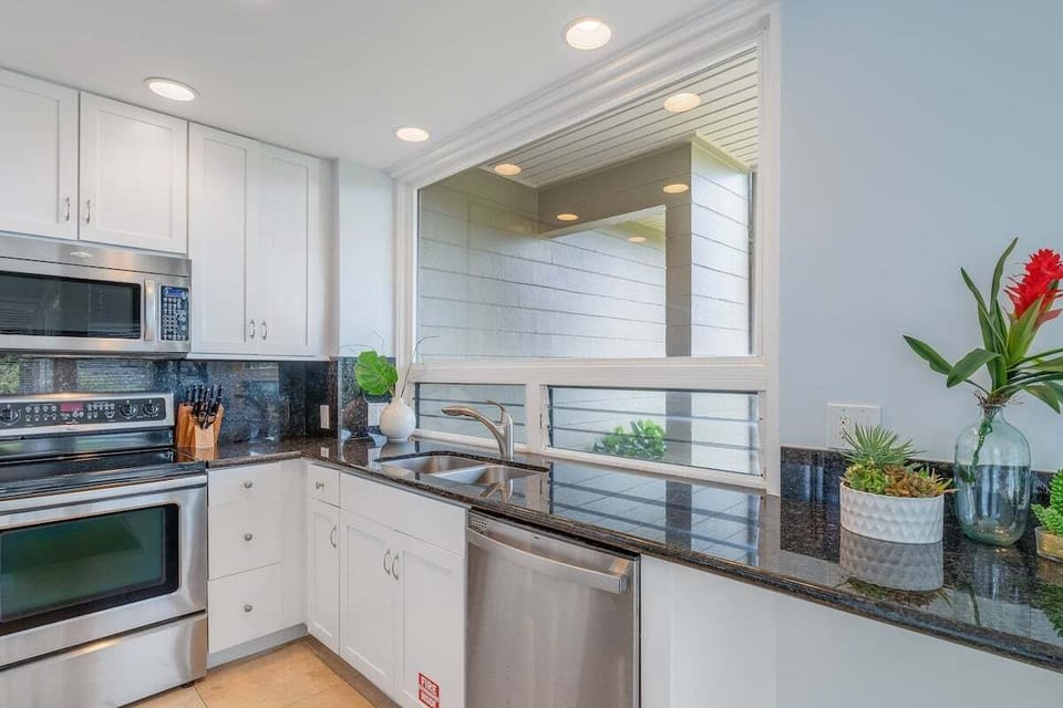 Modern kitchen showcasing granite countertops, ample cabinetry, and a functional layout ideal for cooking and entertaining.