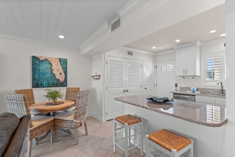 Settle in at the cozy breakfast bar or gather around the dining table—your coastal-chic kitchen and dining nook are ready for morning coffee and vacation meals together.