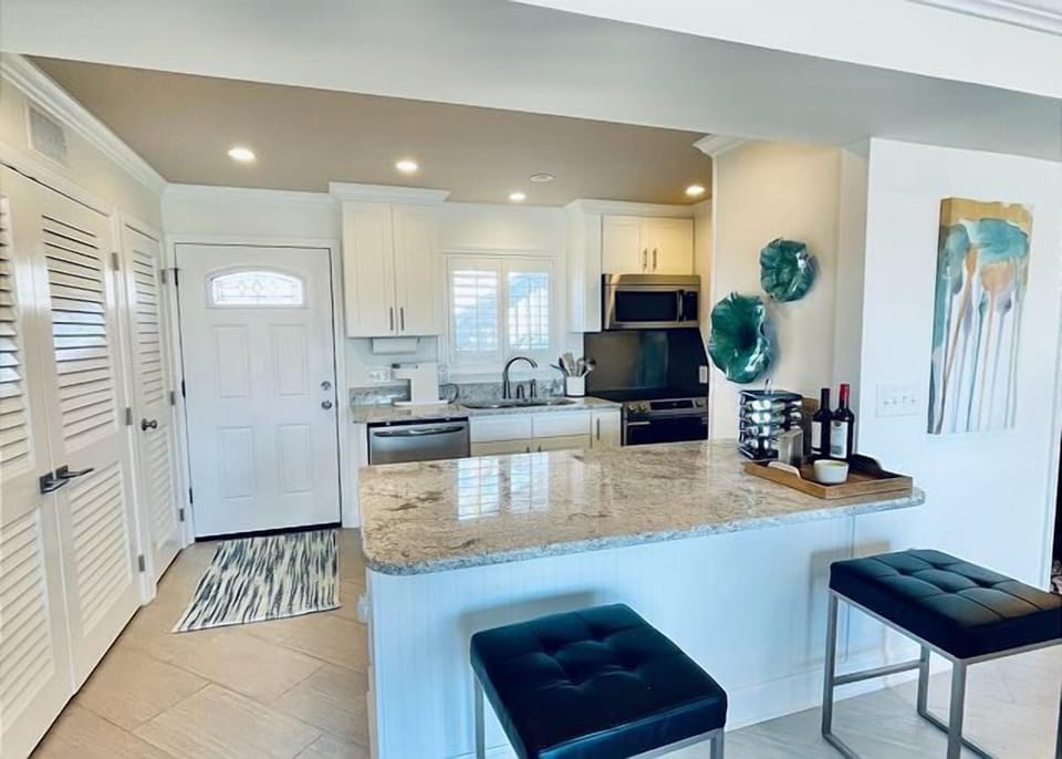Your fully equipped kitchen awaits with granite countertops, stainless appliances, and a breakfast bar where you can sip morning coffee while planning your day.
