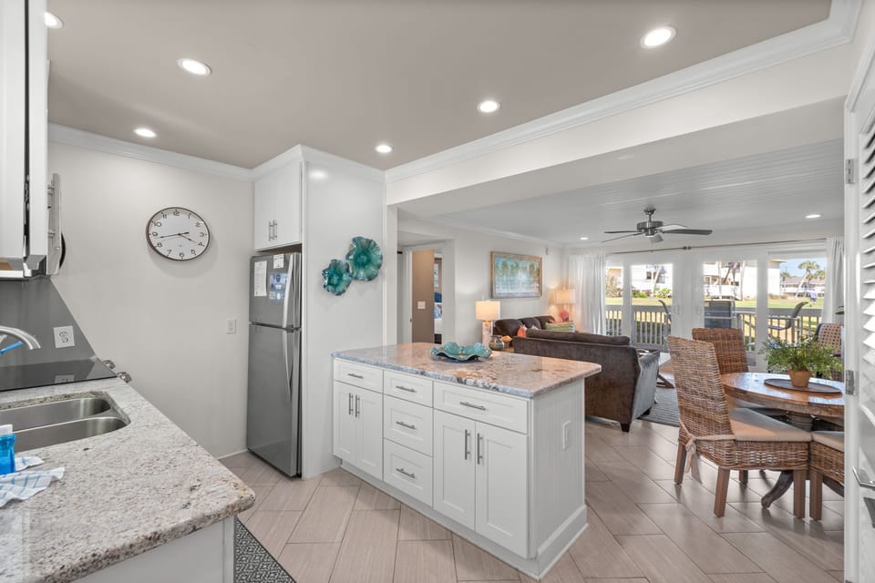 This bright, open-concept space seamlessly connects your kitchen, dining, and living areas, perfect for gathering and enjoying relaxed coastal living together.