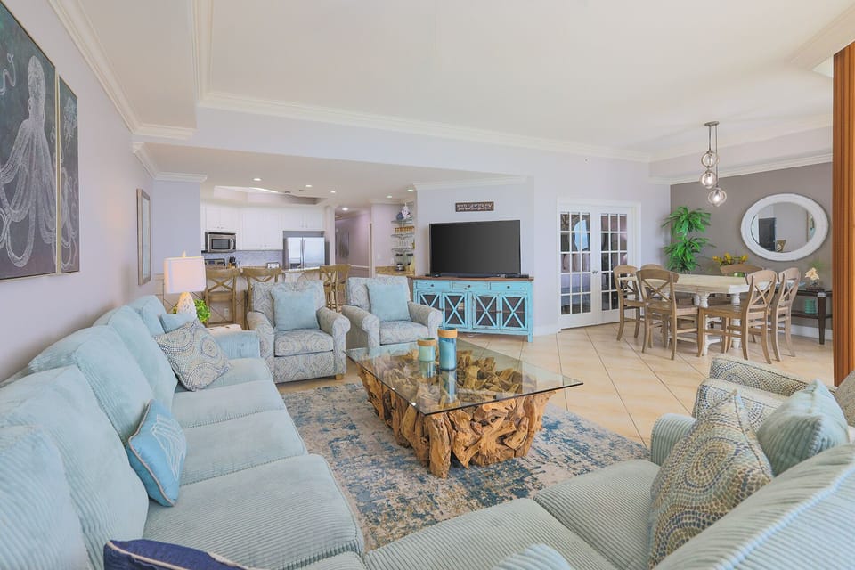 This inviting living area features a large TV and a unique wooden coffee table, perfect for relaxing with family and friends