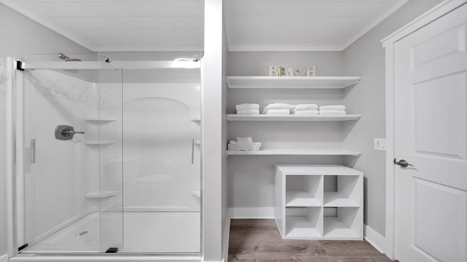 Full bathroom has plenty of shelving to accommodate multiple guests' belongings. 