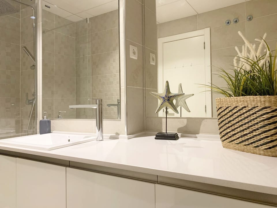 Stylish bathroom featuring a walk-in shower, toilet, and modern vanity