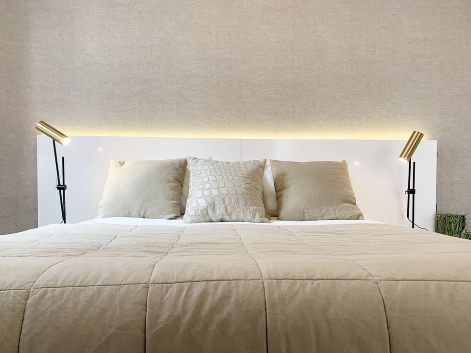 Well-lit bedroom, with full-size bed and all the amenities