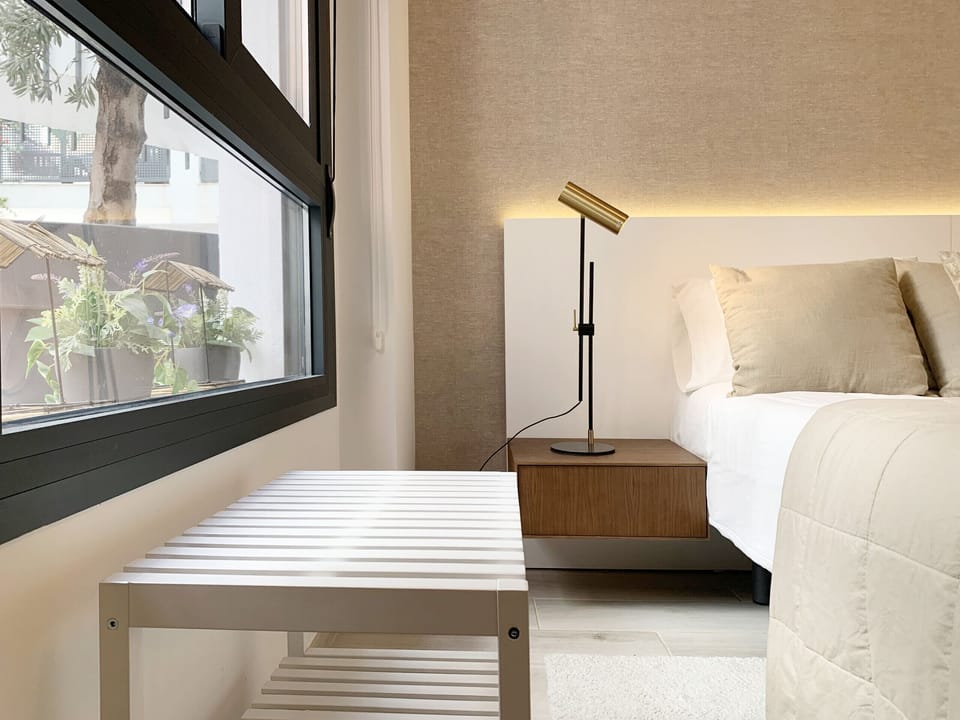 Well-lit bedroom, with full-size bed and all the amenities
