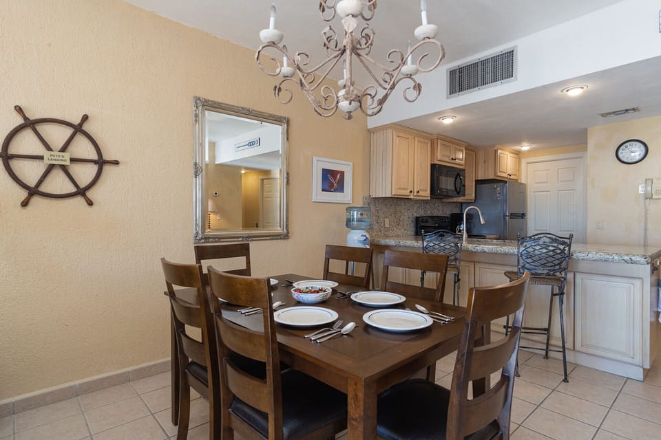 The dining table and kitchen.