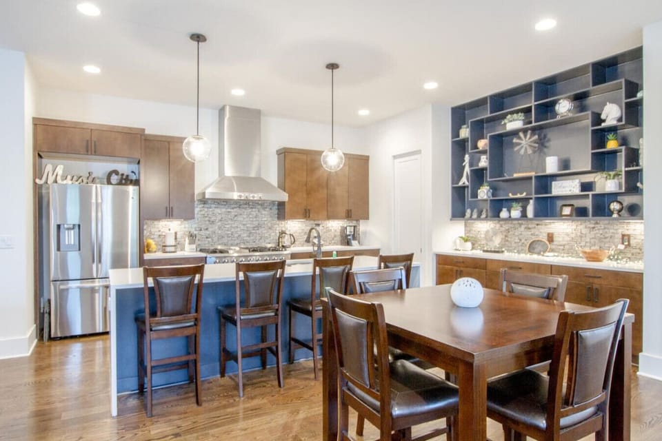 A large open dining area with industrial pendant lighting seats the whole group for meals.