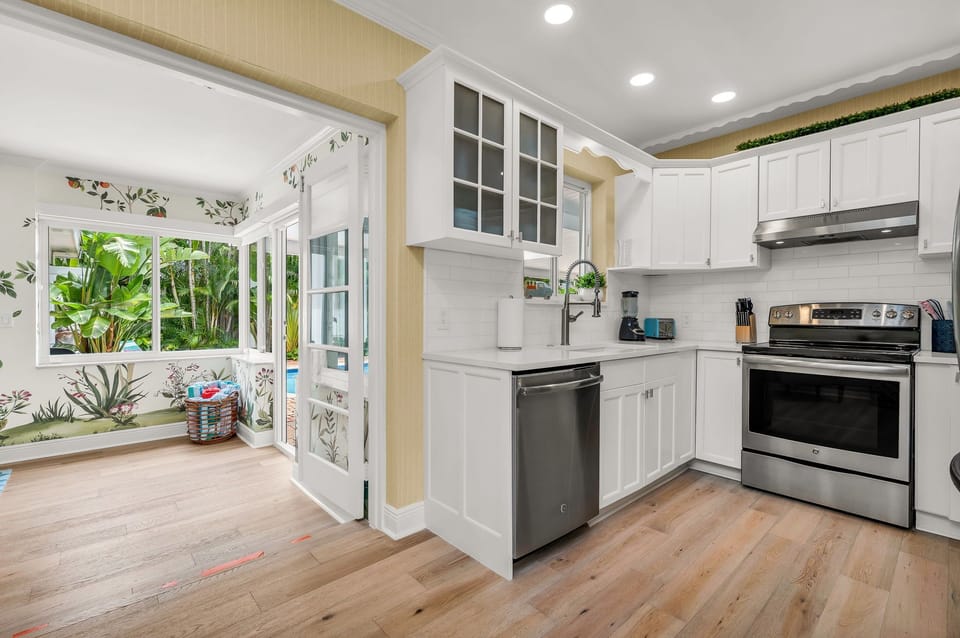 The luminous, fully-equipped kitchen serves as a culinary haven, perfect for post-beach gatherings or sunset cookouts. It's thoughtfully stocked with all the essentials for cooking, whether you're dining indoors or outdoors.