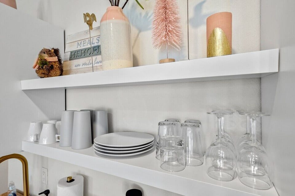 Dishware can be found above the sink.