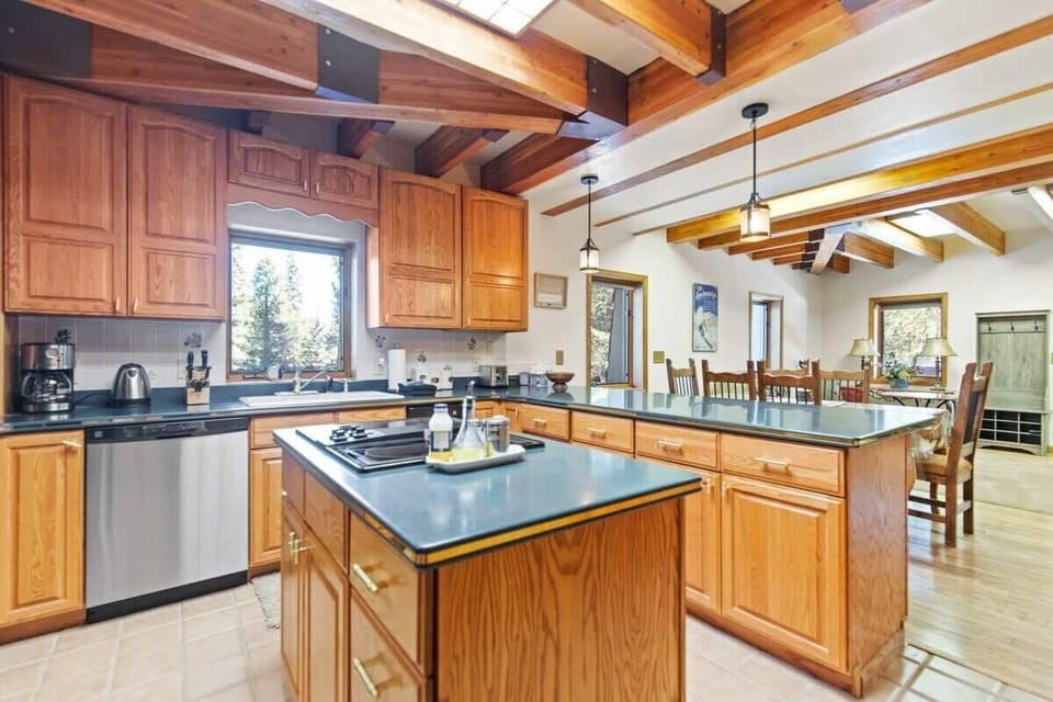 Plenty of cabinet and counter space, stainless steel appliances and lots of natural light streaming in from the skylights, make this kitchen open and inviting.