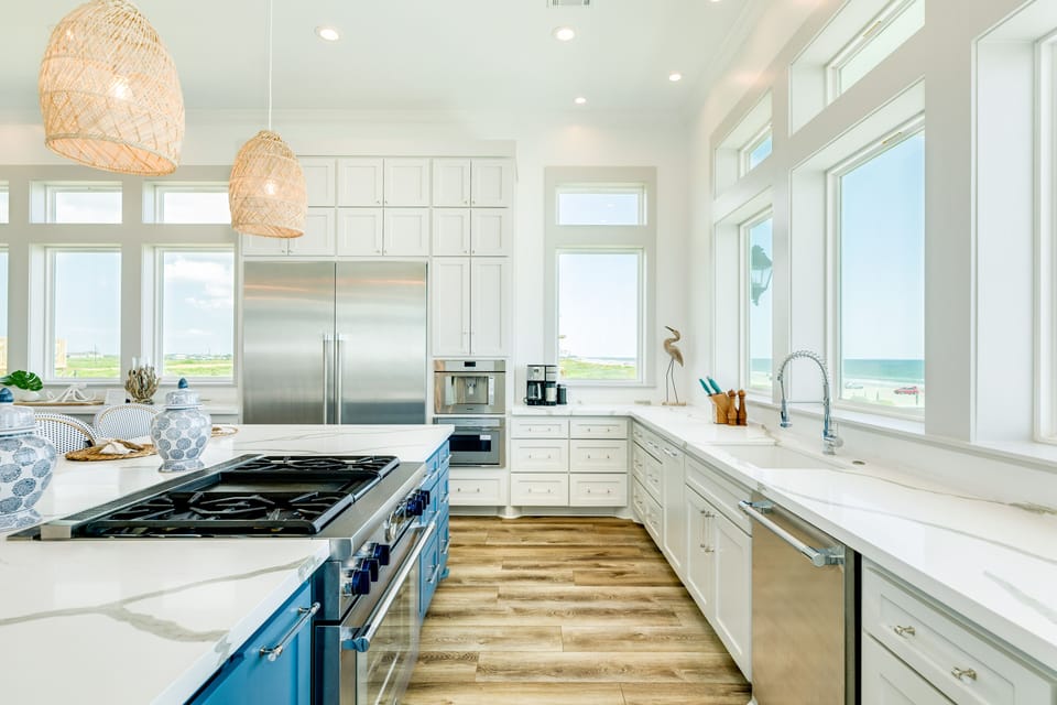 Kitchen with stainless steel appliances including a full size side-by-side refrigerator